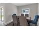 Dining room area featuring a wooden dining table with six chairs and a view to the backyard at 7229 Spring Snowflake Ave, Tampa, FL 33619