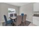 Dining room area featuring a wooden dining table with six chairs and a sunny window at 7229 Spring Snowflake Ave, Tampa, FL 33619
