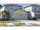 Charming two-story home featuring a two-car garage and well-maintained lawn and landscaping at 7229 Spring Snowflake Ave, Tampa, FL 33619