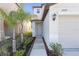 Charming home features a walkway to the front door, a two-car garage and manicured landscaping at 7229 Spring Snowflake Ave, Tampa, FL 33619