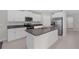 Modern kitchen with stainless steel appliances, white cabinetry and stone countertops at 7229 Spring Snowflake Ave, Tampa, FL 33619