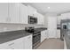 Modern kitchen with stainless steel appliances, white cabinetry, and granite countertops at 7229 Spring Snowflake Ave, Tampa, FL 33619