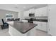 Modern kitchen with stainless steel appliances, white cabinetry, and a breakfast table at 7229 Spring Snowflake Ave, Tampa, FL 33619