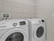 Laundry room featuring white Samsung washer and dryer at 7229 Spring Snowflake Ave, Tampa, FL 33619