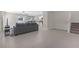 Spacious living room with gray sofa, an open layout, and view of the staircase and kitchen at 7229 Spring Snowflake Ave, Tampa, FL 33619