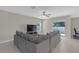 Spacious living room featuring tile floors, a ceiling fan and access to the backyard through sliding glass doors at 7229 Spring Snowflake Ave, Tampa, FL 33619