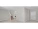 View of the living room featuring staircase and laundry room alcove with tile flooring at 7229 Spring Snowflake Ave, Tampa, FL 33619