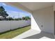 Covered patio features a concrete floor, views of the fenced backyard and green grass at 7229 Spring Snowflake Ave, Tampa, FL 33619