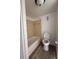 Tiled bathtub and toilet in a bathroom with wood-look flooring and updated fixtures at 7529 Pitch Pine Cir # 190, Tampa, FL 33617