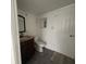 Bathroom featuring a granite vanity, a modern mirror, and updated fixtures at 7529 Pitch Pine Cir # 190, Tampa, FL 33617