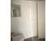 Bathroom showcasing a mirrored vanity and storage shelves, next to a door at 7529 Pitch Pine Cir # 190, Tampa, FL 33617