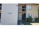 Exterior view of a tan apartment building with visible unit numbers and a small garden area at 7529 Pitch Pine Cir # 190, Tampa, FL 33617