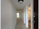 Hallway leading to rooms, displaying carpeted flooring and white walls at 7529 Pitch Pine Cir # 190, Tampa, FL 33617