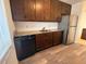 Kitchen with a stainless steel refrigerator, dark cabinetry, granite countertops, and wood-look flooring at 7529 Pitch Pine Cir # 190, Tampa, FL 33617