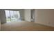 Living room with sliding glass doors and an open doorway to another room at 7529 Pitch Pine Cir # 190, Tampa, FL 33617