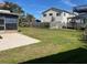 Backyard featuring a well-maintained lawn, a charming fence, and ample space for outdoor enjoyment and entertaining at 842 180Th E Ave, Redington Shores, FL 33708