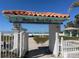 Surfside Beach Club entrance leading to a sandy beach on a bright, sunny day at 842 180Th E Ave, Redington Shores, FL 33708