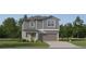 Two-story home featuring lap siding and board and batten accents, a two-car garage, and low-maintenance landscaping at 8440 Sea Ray Run, Parrish, FL 34219