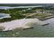 Scenic aerial view of a sandy beach with gentle waves, rock formations, and clear blue water at 902 Chipaway Dr, Apollo Beach, FL 33572