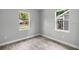 Empty bedroom featuring hardwood floors and natural light from the windows at 9303 N 19Th St, Tampa, FL 33612