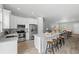 Open concept kitchen with stainless steel appliances and an island with breakfast bar at 9303 N 19Th St, Tampa, FL 33612