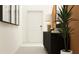 Inviting hallway with a modern console table, decorative lamp, and stylish wall art at 9490 Runaway Breeze Dr, Land O Lakes, FL 34637