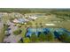 Community aerial view with pool, playground, sports courts, pond, and lush greenery at 9681 Runaway Breeze Dr, Land O Lakes, FL 34637