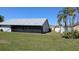 Backyard featuring a well-maintained lawn, screened-in lanai, and perimeter fencing at 2105 Haydon Ct, Brandon, FL 33511