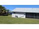View of the home's rear exterior and spacious backyard with lush green grass at 2105 Haydon Ct, Brandon, FL 33511