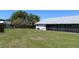 Expansive backyard featuring a lush lawn, privacy fence, and screened-in lanai at 2105 Haydon Ct, Brandon, FL 33511
