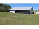 Backyard featuring a well-maintained lawn, screened-in lanai, and perimeter fencing at 2105 Haydon Ct, Brandon, FL 33511