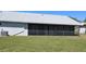 Exterior of the home with a screened in lanai and a lush green lawn at 2105 Haydon Ct, Brandon, FL 33511
