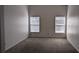 Neutral, carpeted bedroom with two windows offering plenty of natural light at 2105 Haydon Ct, Brandon, FL 33511