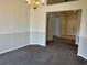 Dining room with neutral carpeting, wainscoting, and a decorative chandelier fixture at 2105 Haydon Ct, Brandon, FL 33511