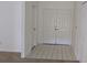 Bright, tiled foyer featuring double entry doors and ample closet space at 2105 Haydon Ct, Brandon, FL 33511