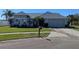Charming single-story home featuring a manicured lawn, gray paint, and a two-car garage at 2105 Haydon Ct, Brandon, FL 33511