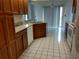 Bright kitchen featuring wood cabinets, light countertops, white appliances, and tile floors at 2105 Haydon Ct, Brandon, FL 33511