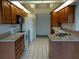 Open kitchen featuring tile floors, light countertops, wood cabinets, and white appliances at 2105 Haydon Ct, Brandon, FL 33511