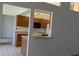 Kitchen passthrough featuring wood cabinets, a breakfast bar, and tile flooring at 2105 Haydon Ct, Brandon, FL 33511