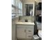 Well-lit bathroom with a vanity with a sink and a mirror, and a toilet at 10126 Bahama Ct, Seminole, FL 33776