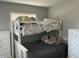 Cozy bedroom with a bunk bed, two dressers, and natural lighting from a window at 10126 Bahama Ct, Seminole, FL 33776