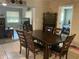 Open-concept dining room with a dark wood table, chairs, and view of the living room and bedroom at 10126 Bahama Ct, Seminole, FL 33776