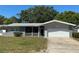 Charming single-story home featuring neutral paint, a white two-car garage, and a well-maintained front lawn at 10126 Bahama Ct, Seminole, FL 33776
