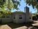 Home exterior features a modern design, chimney, and lush landscaping, offering a blend of comfort and style at 10126 Bahama Ct, Seminole, FL 33776