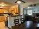 Kitchen with wood cabinets, white appliances, and an open layout overlooking the dining and living area at 10126 Bahama Ct, Seminole, FL 33776