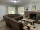 Comfortable living room features a brick fireplace, neutral walls, and comfortable seating at 10126 Bahama Ct, Seminole, FL 33776