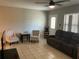 Inviting living room featuring tile floors, a ceiling fan, and comfortable seating at 10126 Bahama Ct, Seminole, FL 33776
