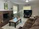 Bright living room with a brick fireplace, neutral walls, and an inviting sitting area at 10126 Bahama Ct, Seminole, FL 33776