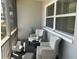 Cozy screened porch with seating featuring plush chairs, foot stools, and a small round table at 10126 Bahama Ct, Seminole, FL 33776