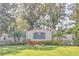 Elegant entrance sign for Fox Wood at Trinity surrounded by manicured landscaping and flowering plants at 10641 Firebrick Ct, Trinity, FL 34655